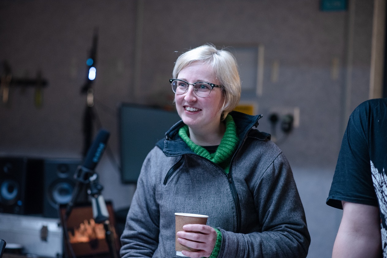 Director Antonia Bain holding a cup of coffee during filming of The Narcissistic Fish
