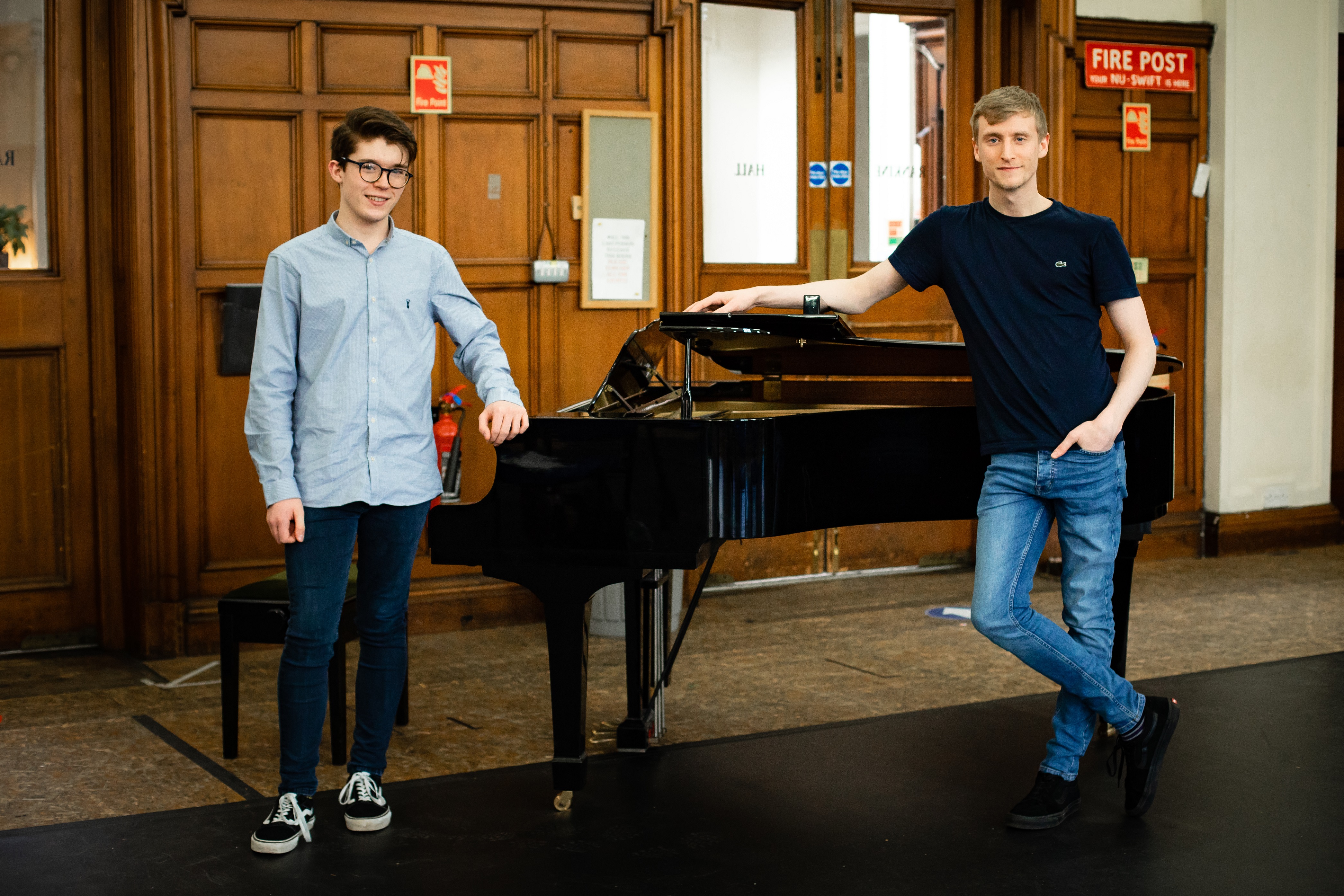 Two Young Company members, Ruaraidh McBain and Dillon McFarlane, standing either side of a piano