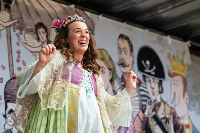 Stephanie Stanway in Pop-up Opera, smiling and wearing a purple, green and white princess gown and tiara
