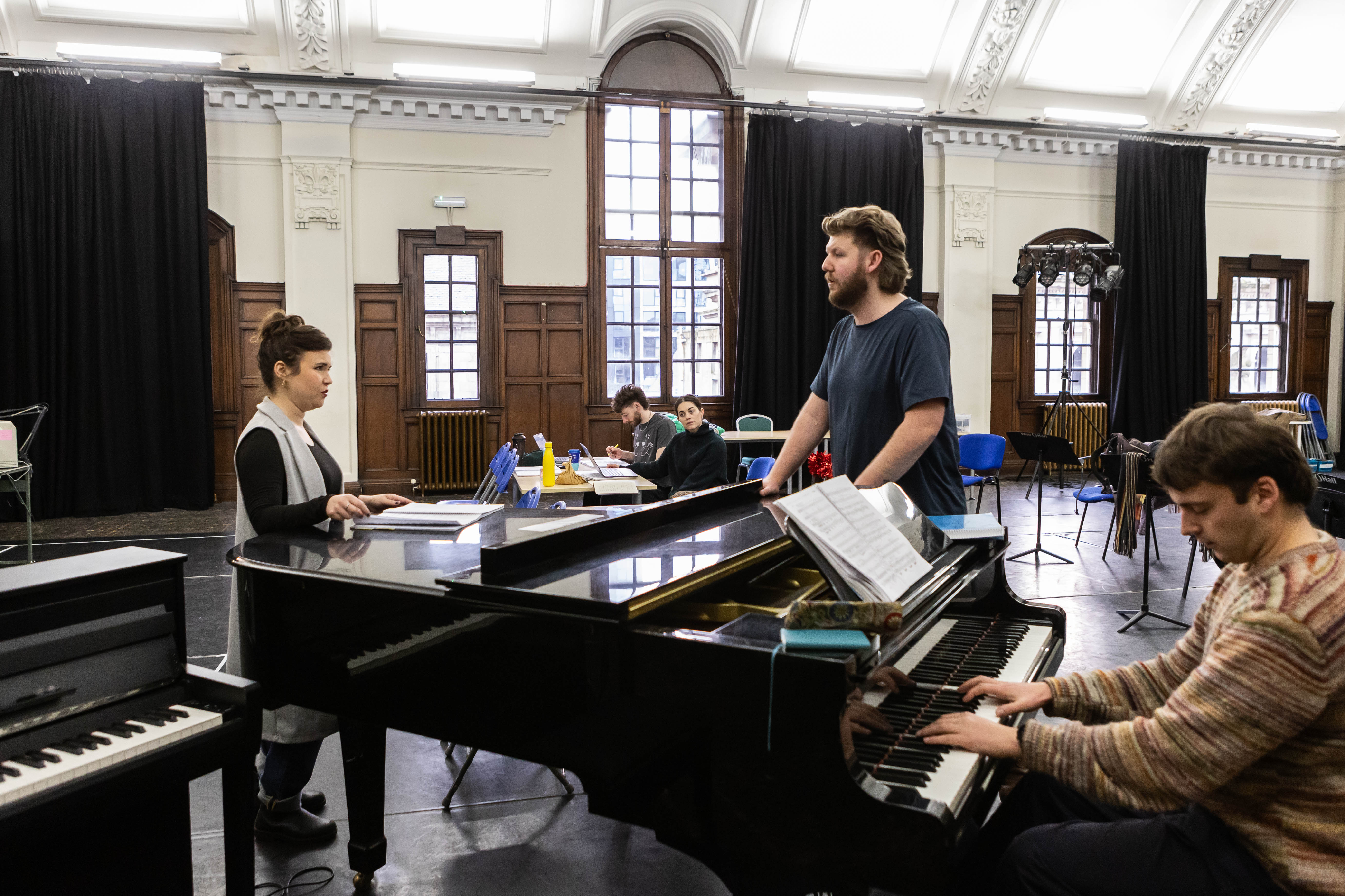 Kira Kaplan, Daniel Barrett And Music Director, Toby Stanford, In The Office Party Rehearsals. Credit Sally Jubb..